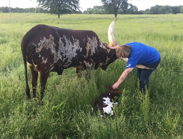 Cindy Sims scritching the baby.