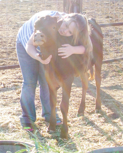 Katelyn hugging Sierra Rose, FP heifer. (Photo by Joanne Hethcox)